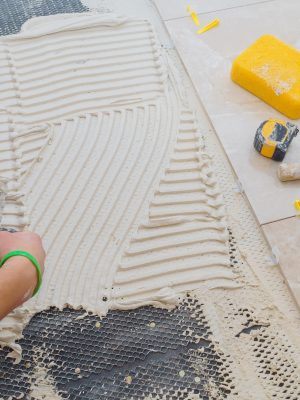 Floor tiles installation. Ceramic tiles and tools for home improvement, renovation Floor tiles installation. Ceramic tiles and tools for home improvement, renovation